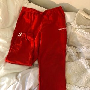 Red Adidas track sweatpants